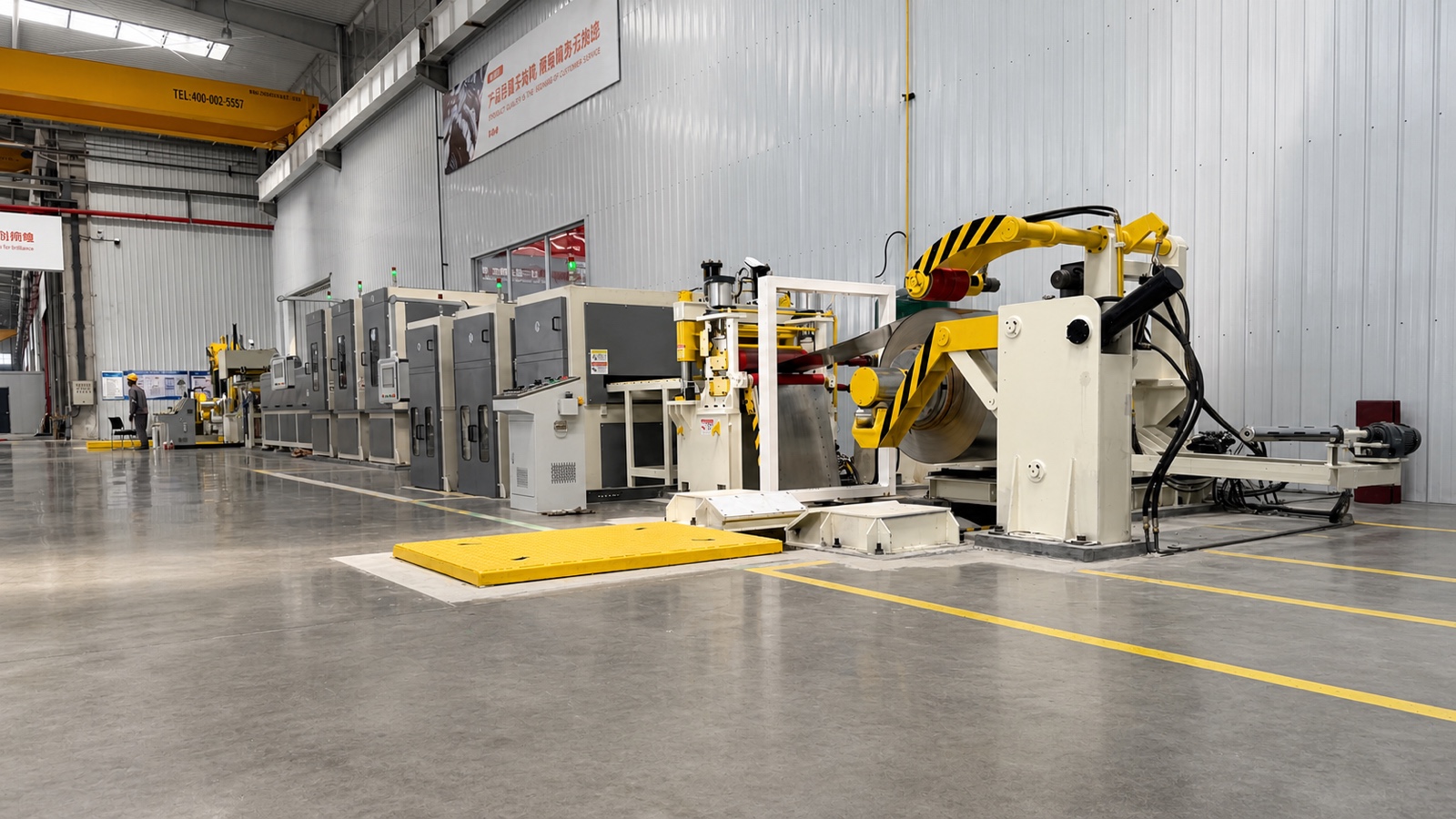 Wide view of the recoiling end of the titanium coil polishing line