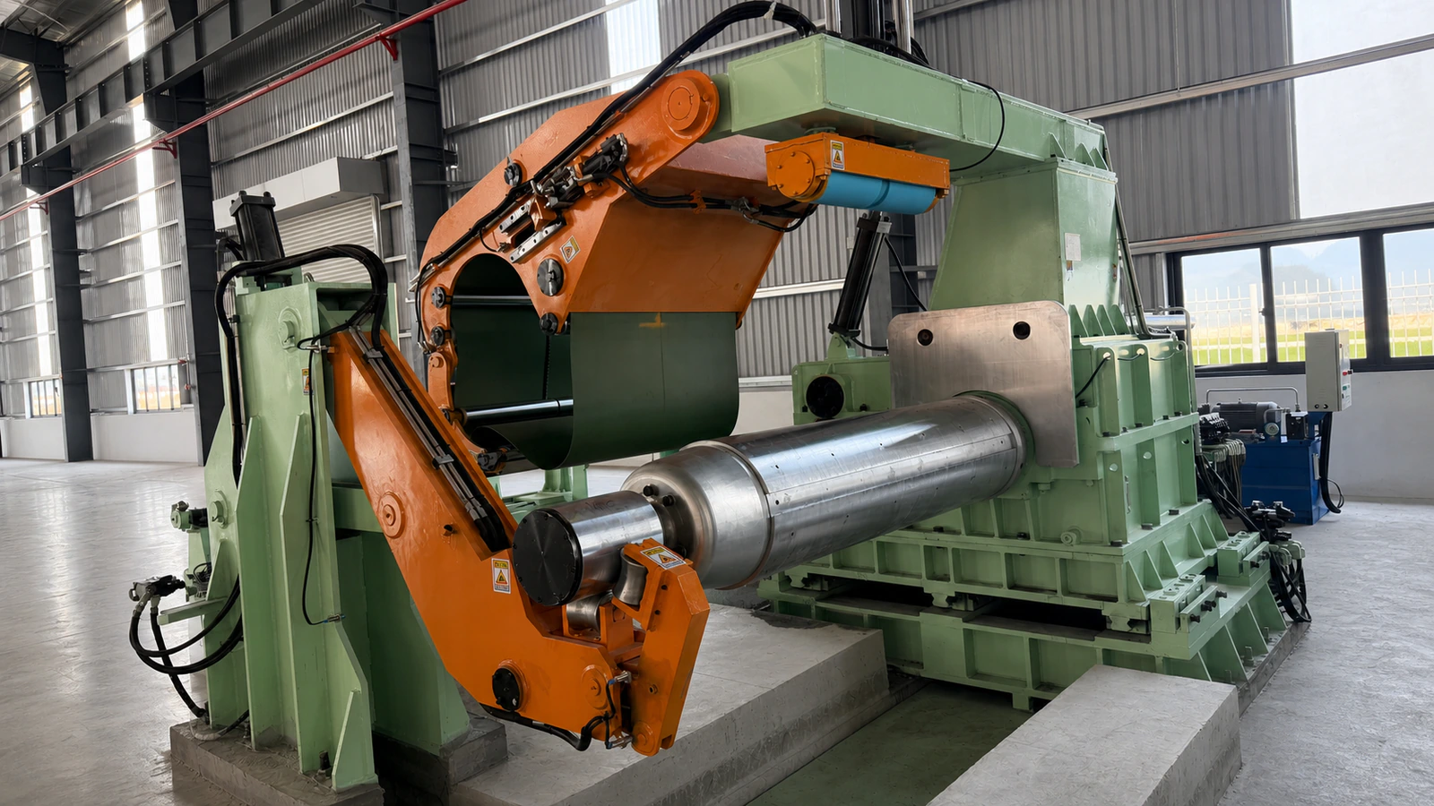 Coil recoiling machine with hydraulic mandrel and pressure arm