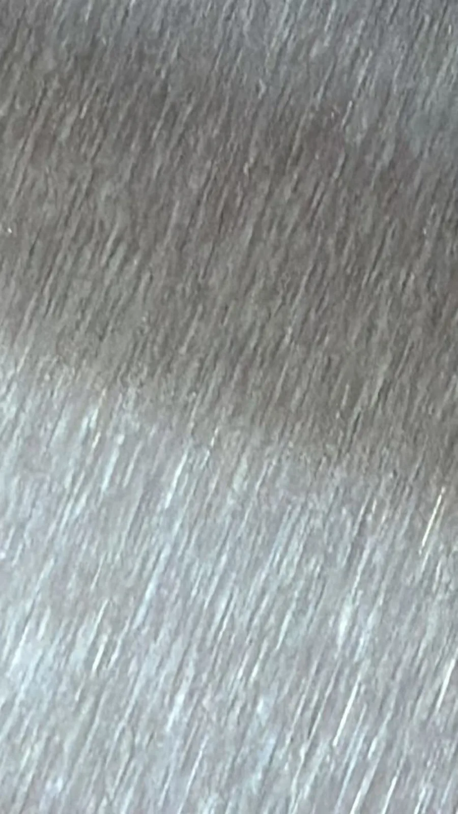 Close-up of uniform abrasive grain on aluminum coil surface