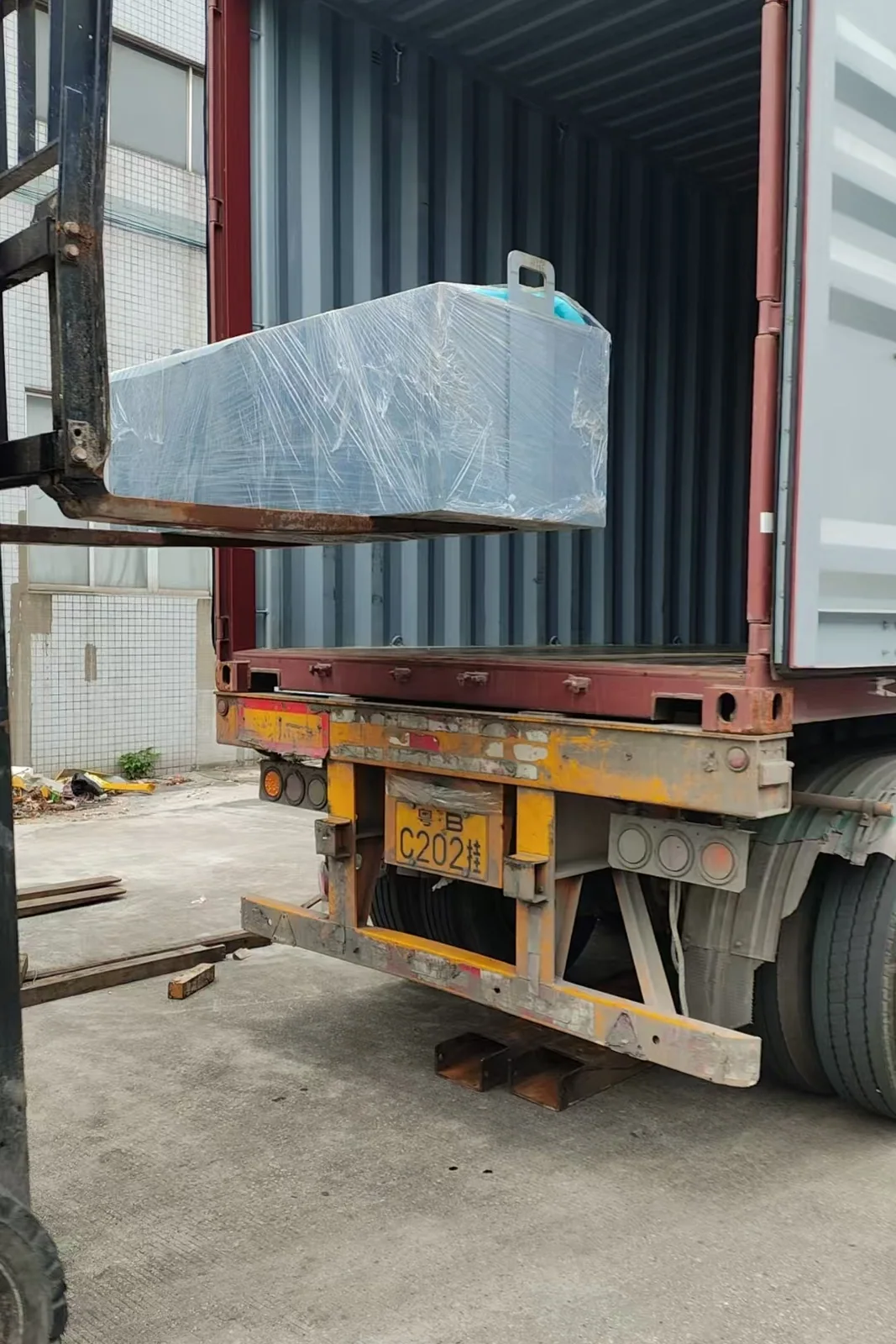 Wrapped equipment module on the forklift during loading.
