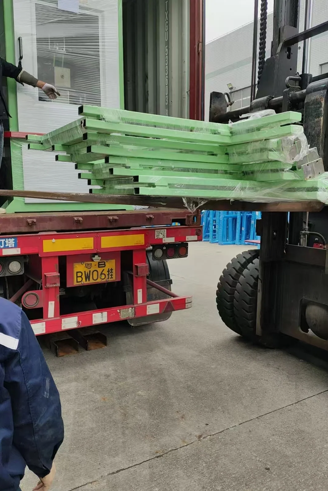 Line frames and roller tables stacked and wrapped for transport.